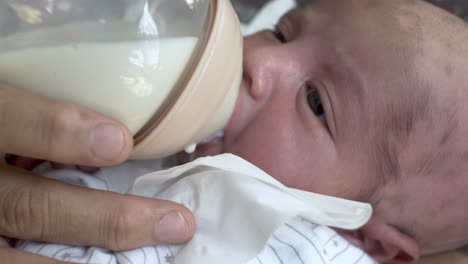 Feeding-newborn-baby-with-breast-milk-from-a-bottle,-close-up