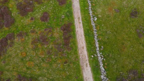 Overhead-shot-of-path-and-rock-wall-in-Lomond-hills-highland,-Scotland