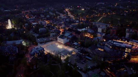 Evening-flyover-of-Zakopane,-Poland,-a-resort-town-against-the-Tatra-Mountains,-and-its-stunning-Goral-traditional-architecture-2
