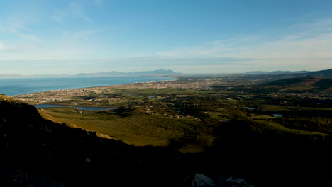Sunrise-elevated-pan-at-Sir-Lowry's-Pass-lookout,-False-Bay-and-Strand-view