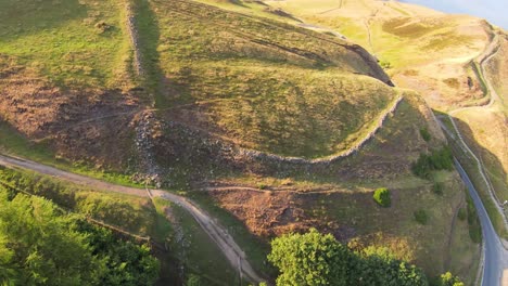 FPV-Drone-shot-just-over-the-high-mountain-ridge-in-the-beautiful-orange-colored-autumn-colors-in-the-peak-district-in-northern-england-then-180-degree-turn-on-a-sunny-day