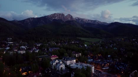 Evening-flyover-of-Zakopane,-Poland,-a-resort-town-against-the-Tatra-Mountains,-and-its-stunning-Goral-traditional-architecture-1
