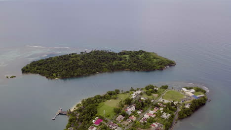 Aerial-view-of-Navy-Island-in-Port-Antonio-in-Jamaica-with-Titchfield-school-and-the-old-hotel-on-the-tip-between-the-east-and-west-harbour-on-a-peaceful-calm-morning