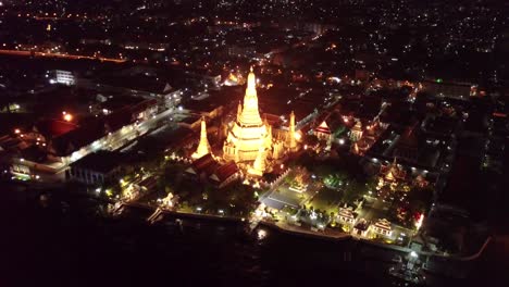 Night-drone-shots-of-Bangkok-near-Wat-Arun-temple,-UHD
