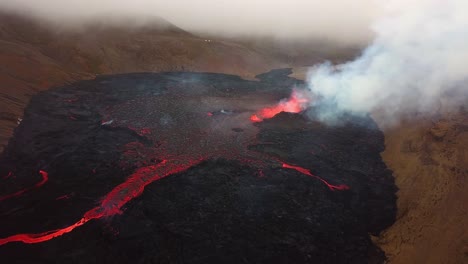 Aerial-landscape-view-of-lava-flowing-across-the-Meradalir-valley-floor-coming-out-of-Fagradalsfjall-volcano