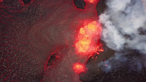 Aerial-top-view-over-lava-erupting-in-Meradalir-valley,-from-Fagradalsfjall-volcano,-with-smoke-coming-out