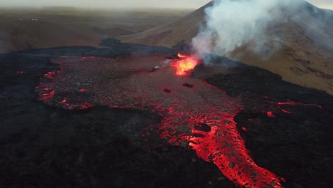 Aerial-landscape-view-of-lava-erupting-in-Meradalir-valley,-from-Fagradalsfjall-volcano,-Iceland