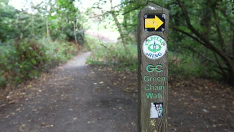 Forest-path-and-signpost-showing-the-right-direction-on-Green-Chain-Walk-in-Oxleas-wood