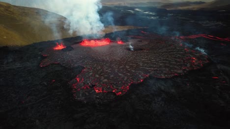 Aerial-panoramic-view-of-magma-and-lava-erupting-in-Meradalir-valley,-from-Fagradalsfjall-volcano,-with-smoke-coming-out