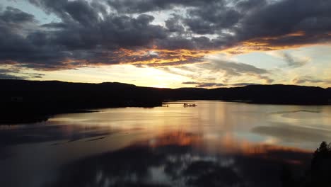 Flying-above-a-lake-in-Norway-with-a-fantastic-sunset-on-the-horizon-2