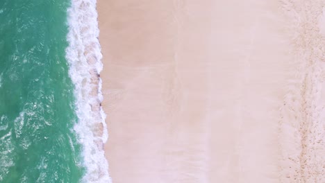 Waves-crashing-on-beach,-abstract-vacation-background,-aerial-top-down-view