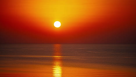 Time-lapse-shot-of-orange-sun-ball-going-down-at-horizon-of-ocean---Golden-sunset-at-sea