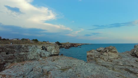 Pan-over-Tyulenovo-cliffs-to-calm-Black-Sea-in-Bulgaria-with-blue-sky