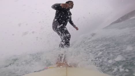 Young-man-surfing-ocean-waves-gopro-angular-view-shot