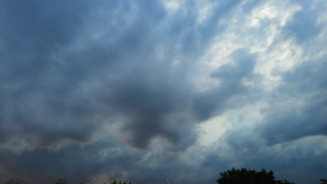 Timelapse-of-dramatic,-dark-storm-clouds-swirling-in-big-grey-sky