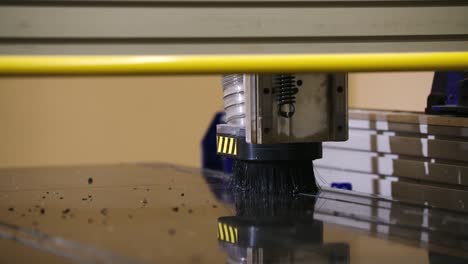A-CNC-router-head-finishes-its-final-cut-on-signage-in-slow-motion-with-debris-flying-off