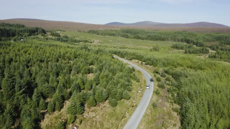 Aerial-view-of-cars-driving-on-a-long,-winding-mountain-road-in-the-Wicklow-Mountains-on-a-sunny-day-7