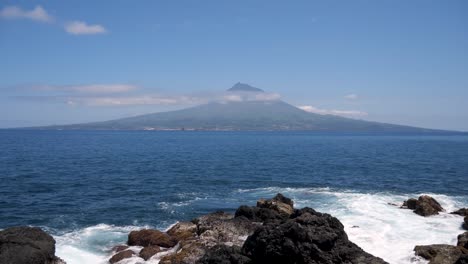Pico-Mountain-in-Azores,-Portugal-,-shot-on-tripod-with-waves-in-foreground