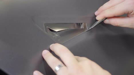 Cutting-Out-Cutout-in-Car-Wrapping-Vinyl-Foil-with-Utility-Knife