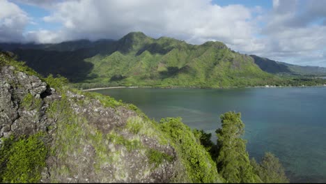 Aerial-reveal-bird's-eye-view-of-Crouching-Lion-Hike-overlooking-Kahana-valley-and-bay,-Hawaii