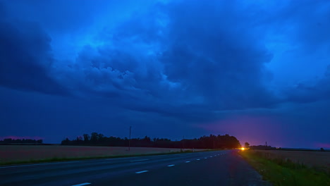 Timelapse-shot-of-lightning-in-distance-over-highway-with-cars-passing-by-during-evening-time
