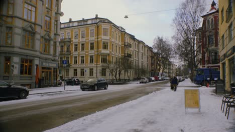 Snowy-city-street-in-Oslo,-Majorstuen-neighborhood-with-cars,-snow,-winter-1