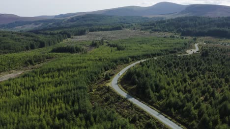 Aerial-view-of-cars-driving-on-a-long,-winding-mountain-road-in-the-Wicklow-Mountains-on-a-sunny-day-5