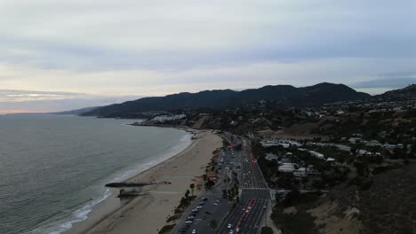 Aerial-view-of-the-Will-Rogers-State-Beach-and-the-Pacific-Coast-Highway-1,-cloudy-sunset-in-Santa-Monica,-CA,-USA