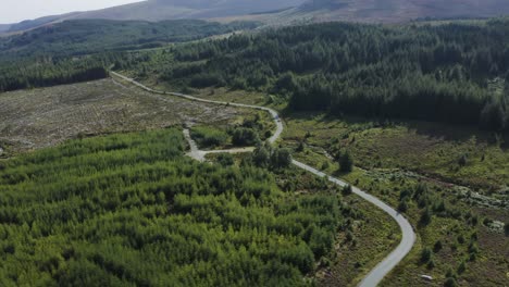 Aerial-view-of-cars-driving-on-a-long,-winding-mountain-road-in-the-Wicklow-Mountains-on-a-sunny-day-4