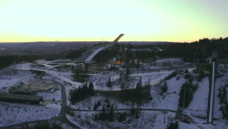 Holmenkollbakken-ski-jump,-Oslo-Vinterpark-Winterpark-Tryvann-Drone-Push-in-Past-Ski-Jump-at-Sunset-Holmenkollen