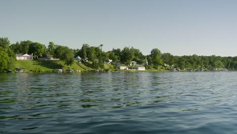 Moving-shot-of-a-shoreline-on-a-lake-in-the-middle-of-summertime
