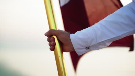 A-knight-holding-Qatar-flag-on-horse-near-the-sea-in-Qatar-desert-1
