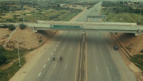 Aerial-Flying-Past-Overpass-Along-Karachi-Motorway