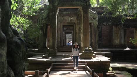 Pan-shot-asian-tourist-walking-out-from-angkor-temple