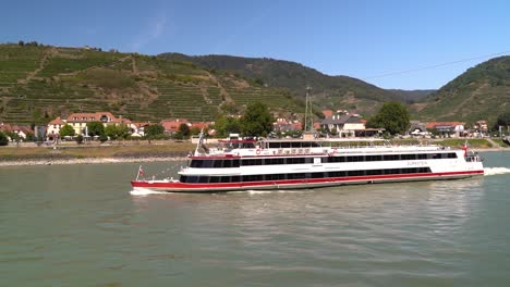 Slow-Motion-view-of-tourist-cruise-ship-on-Danube-River-in-Wachau,-Austria