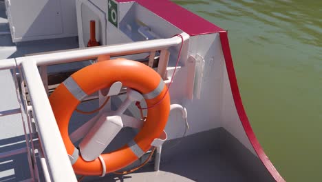 Lifebelt-of-lifebuoy-on-side-of-boat-driving-over-water---close-up-shot