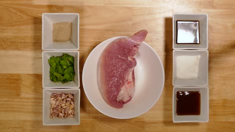 Man,-Hand-Prepare-Adjust-Pork-and-Ingredient-Bowl-in-Order-on-Wooden-Table,-Top-Angle