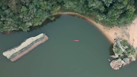 Kayak-paddler-in-calm-water,-aerial-view