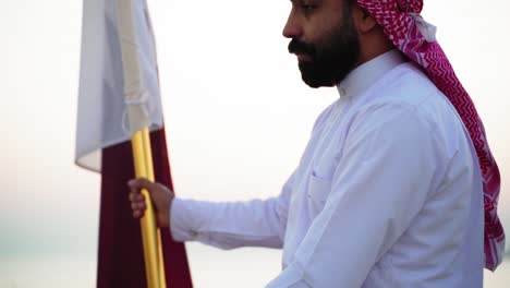 A-knight-riding-a-horse-holding-Qatar-flag-near-the-sea-2