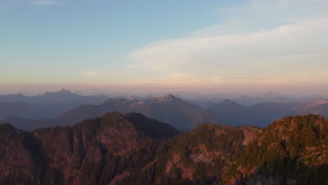 Beautiful-Sunset-Panning-Aerial-Drone-Shot-from-Deeks-Peak-with-Vast-Mountain-Range-and-Incredible-Orange-Lit-Horizon-Pacific-Ranges-Canada-BC-4K