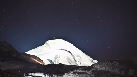 Timelapse:-starry-night-over-an-icy-summit-lighted,-Swiss-alps-mountain