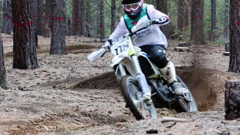 Young-female-on-dirtbike-in-the-forest-at-high-speed-slow-motion,-motocross-60fps