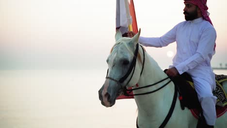 A-knight-on-horse-holding-Qatar-flag-near-the-sea-4