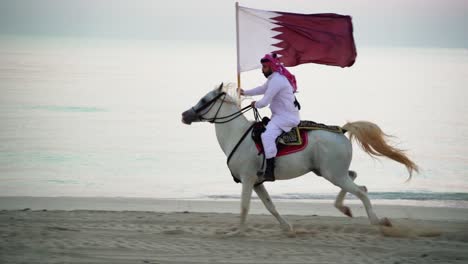 A-knight-riding-a-horse-running-and-holding-Qatar-flag-near-the-sea-2