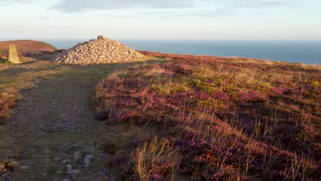 Aerial-Drone-Sideways-Shot-with-Clifftop-Rock-Cairn-and-Dramatic-Sea-Background-Holdstone-Down-UK