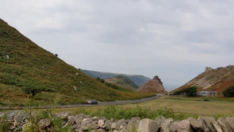 Car-Drives-Through-Dramatic-Valley-of-Rocks-in-Lynton-North-Devon-UK-4K