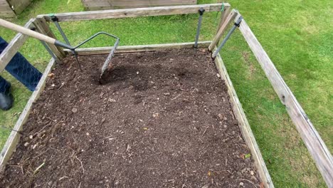 Raking-over-a-small-square-for-planting-potatoes