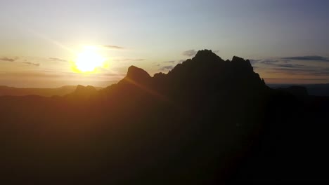 Slow-flying-to-the-top-of-the-Pinnacles-of-Coromandel-Mountains-in-silhouette-at-sunrise