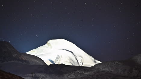 Timelapse:-dark-starry-sky-moves-behind-an-ice-mountain-in-the-Swiss-Alps