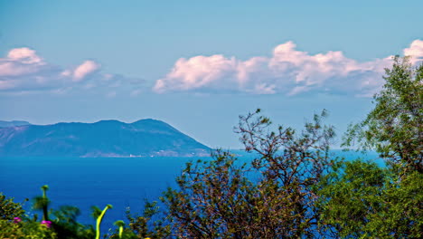 Timelapse-shot-of-seascape-with-beautiful-mountain-range-visible-in-a-distance-at-daytime